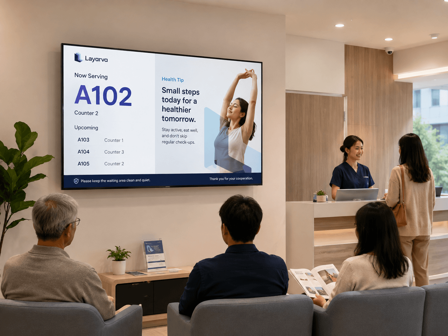 Clinic waiting area with a screen showing queue numbers and health information